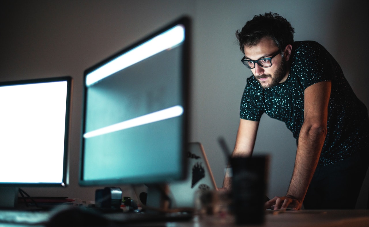 Engineer behind screen dark room