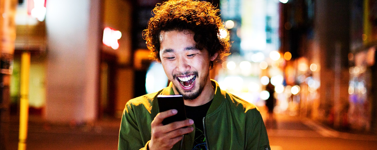 Man laughing with phone