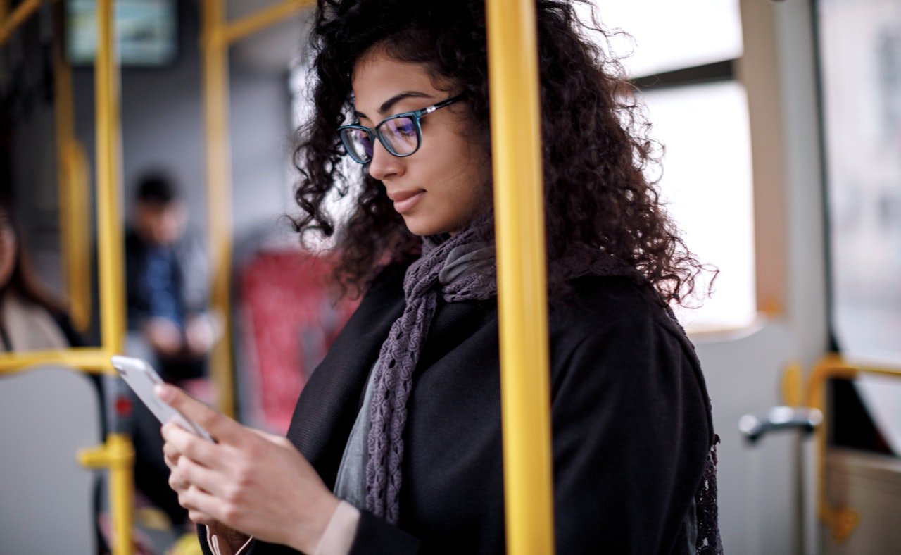 Woman riding bus smartphone