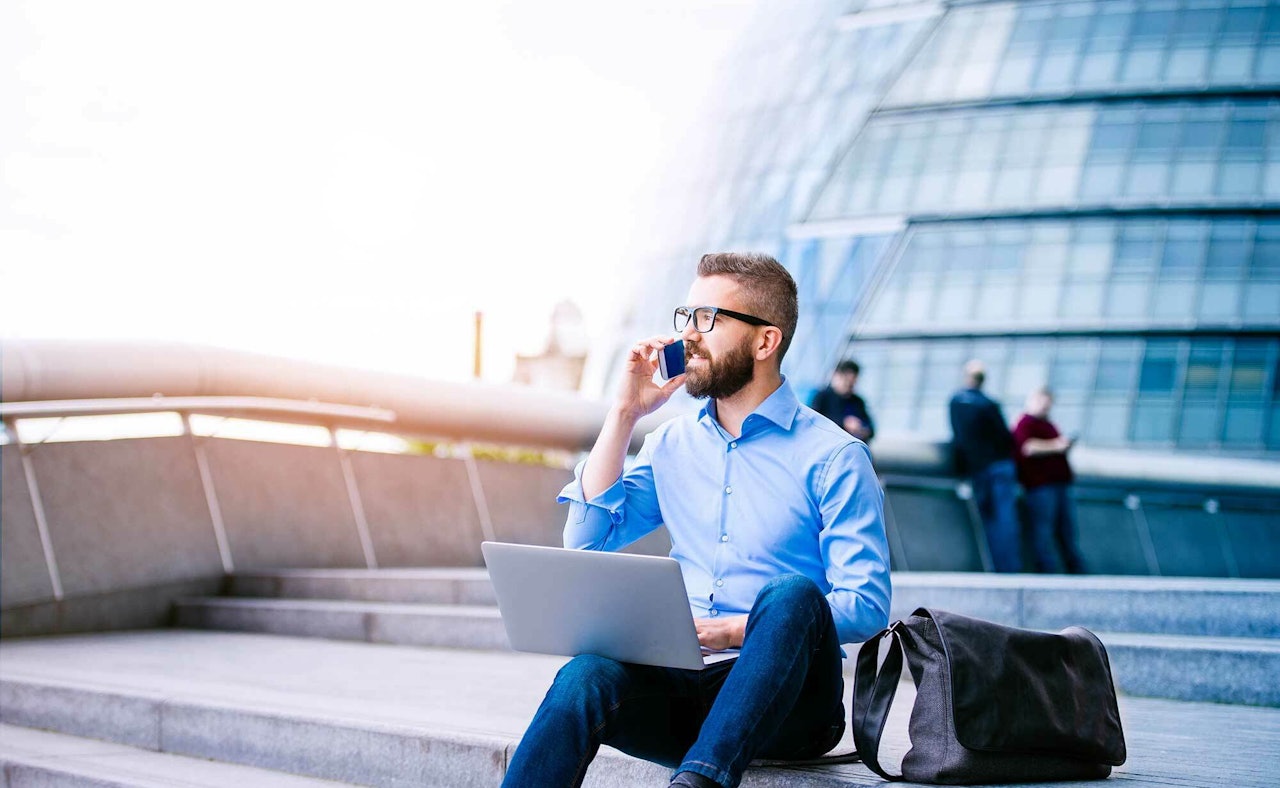 Manager with laptop and smart phone